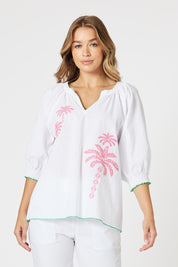 A model wearing the Pina Colada Embroidered Cotton Top in colour White (White), from the front, cropped image