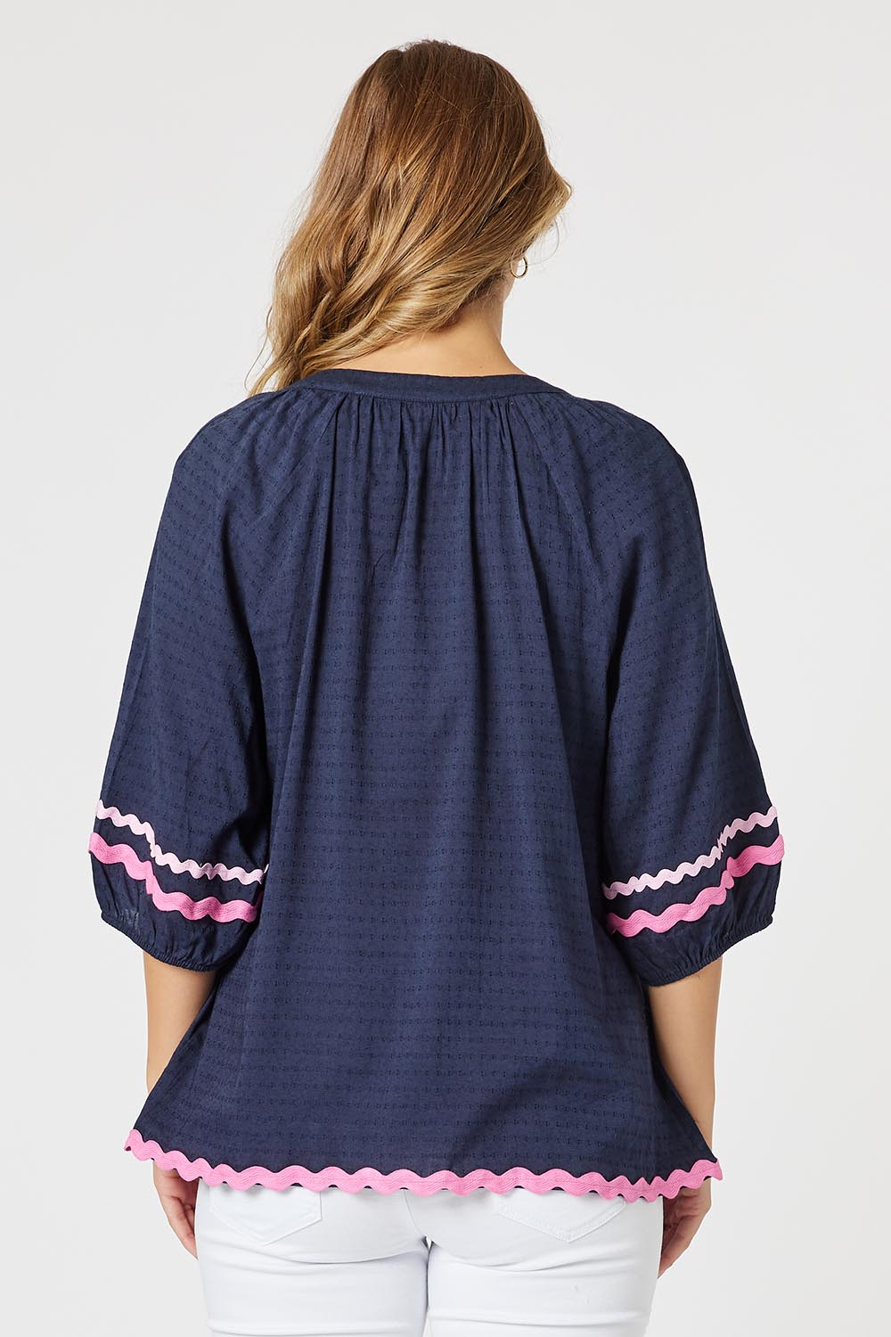 A model wearing the Ric Rac Cotton Top in colour Navy (Blue), from the back