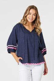 A model wearing the Ric Rac Cotton Top in colour Navy (Blue), from the front, cropped image