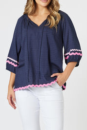 A model wearing the Ric Rac Cotton Top in colour Navy (Blue), from the front, cropped image