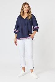 A model wearing the Ric Rac Cotton Top in colour Navy (Blue), from the front, showing the whole outfit