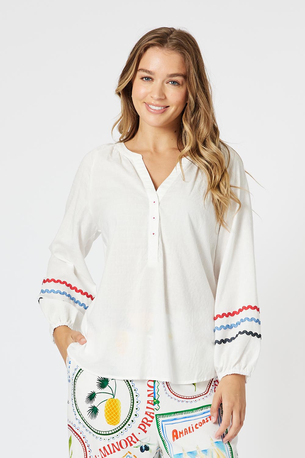 A model wearing the Ric Rac Cotton Tunic in colour Whiteblue (White), from the front, cropped image