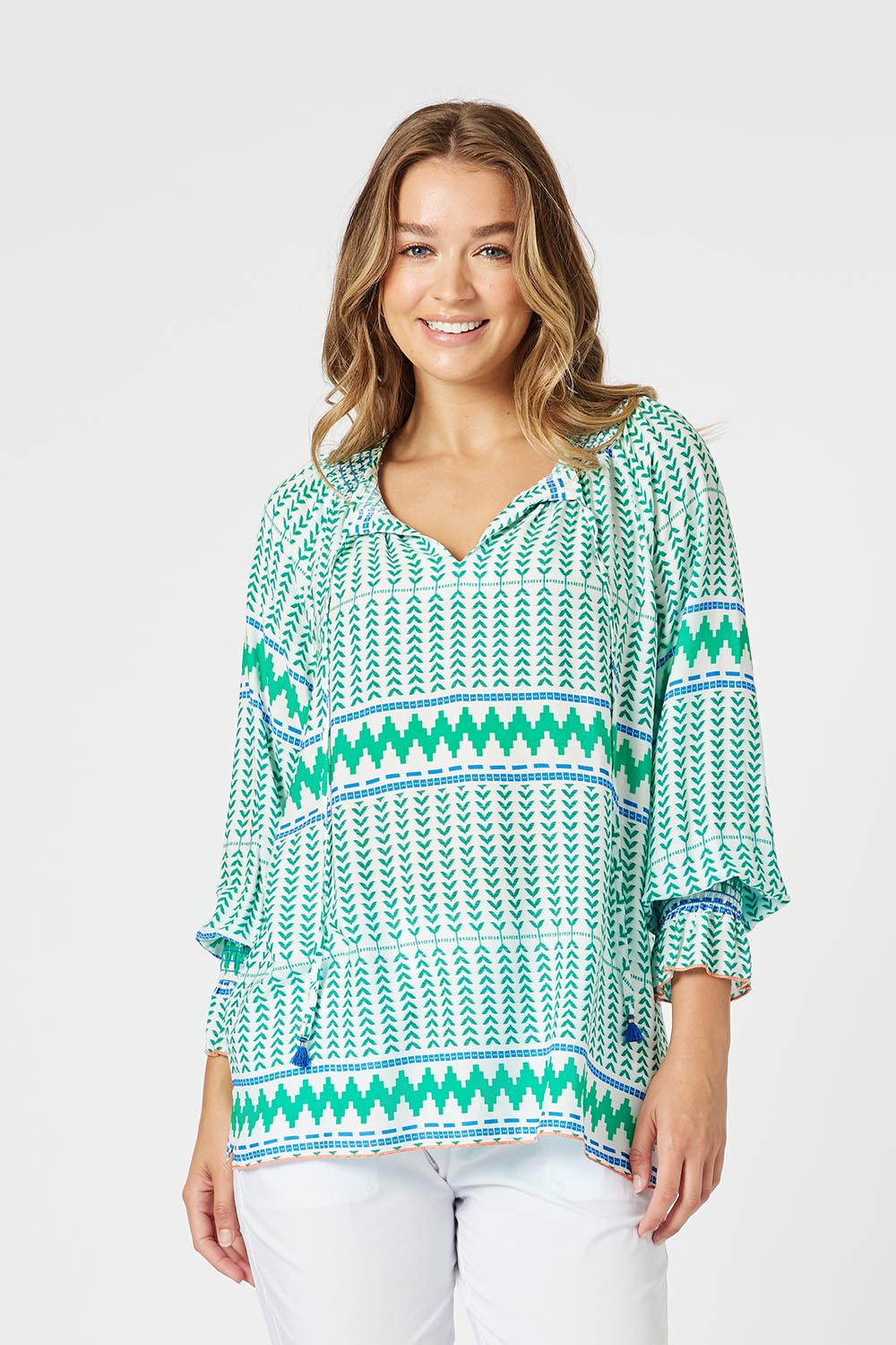 A model wearing the Geo Top in colour Elmmulti (Green), from the front, cropped image