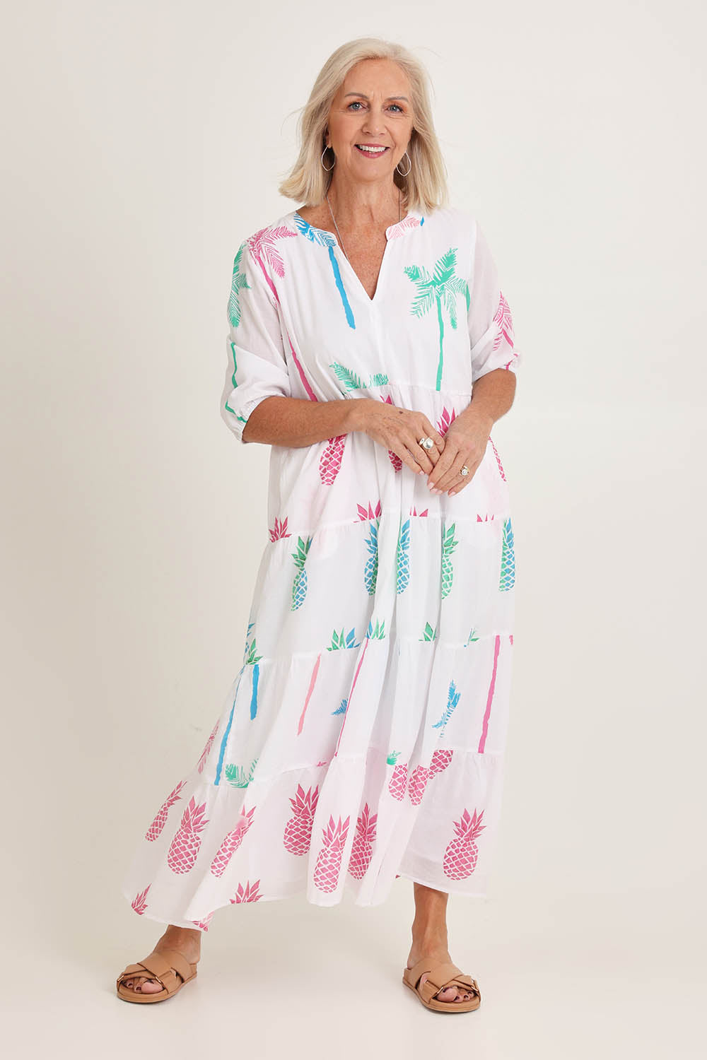 Model Sandy wearing size S of the Pineapple Pina Colada Cotton Dress in colour White (White), from the front, showing the whole outfit
