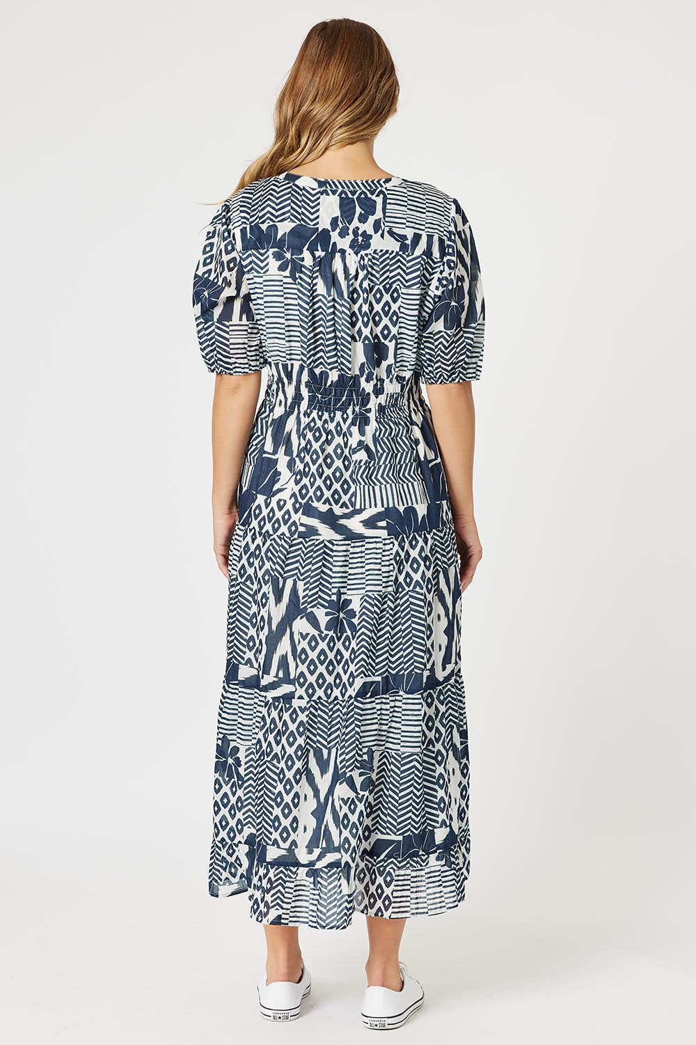 A model wearing the Calabasas Cotton Dress in colour Navy (Blue), from the back