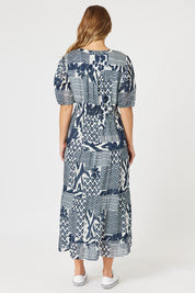A model wearing the Calabasas Cotton Dress in colour Navy (Blue), from the back