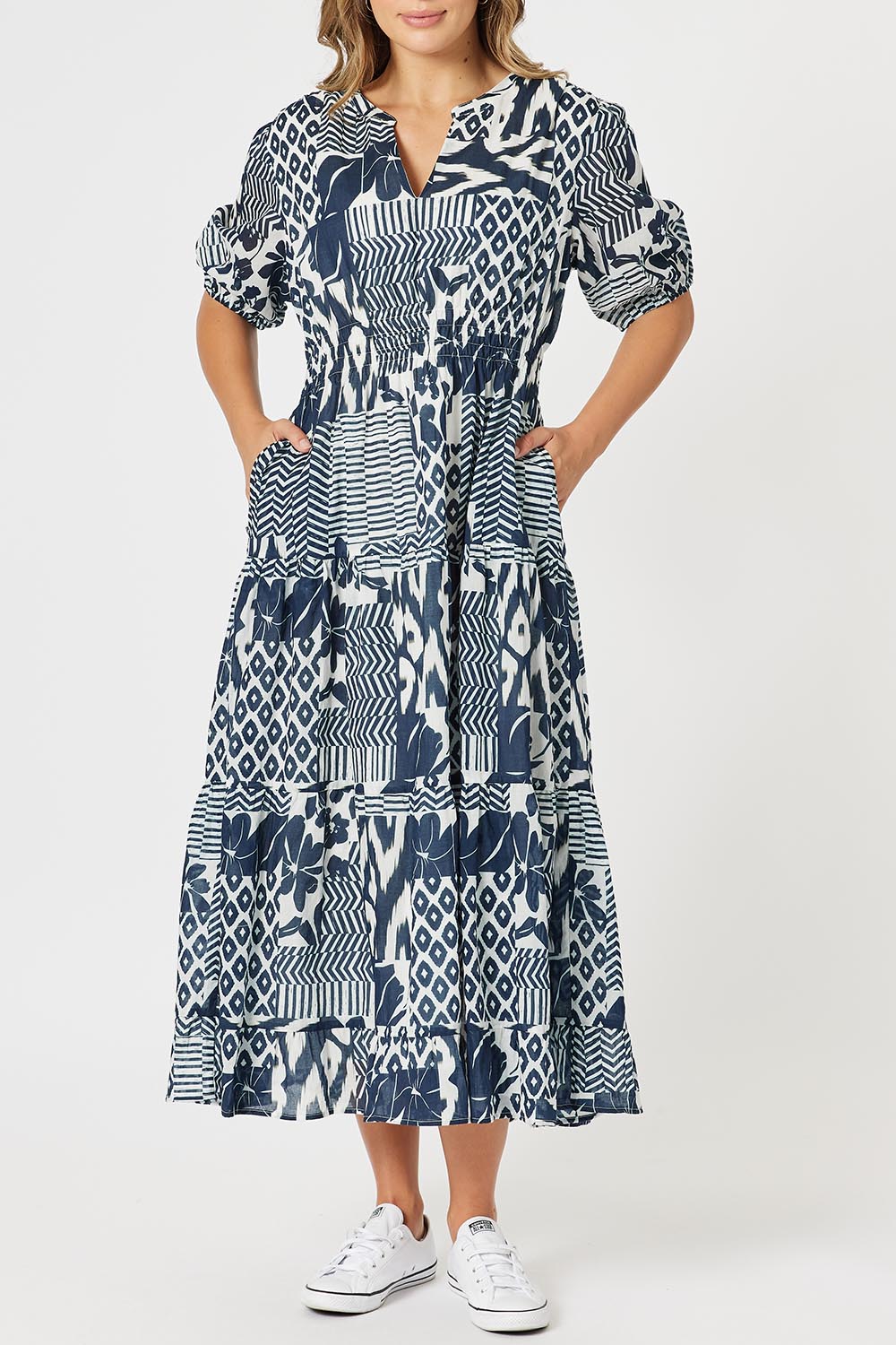 A model wearing the Calabasas Cotton Dress in colour Navy (Blue), from the front, cropped image