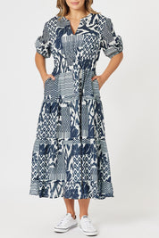 A model wearing the Calabasas Cotton Dress in colour Navy (Blue), from the front, cropped image