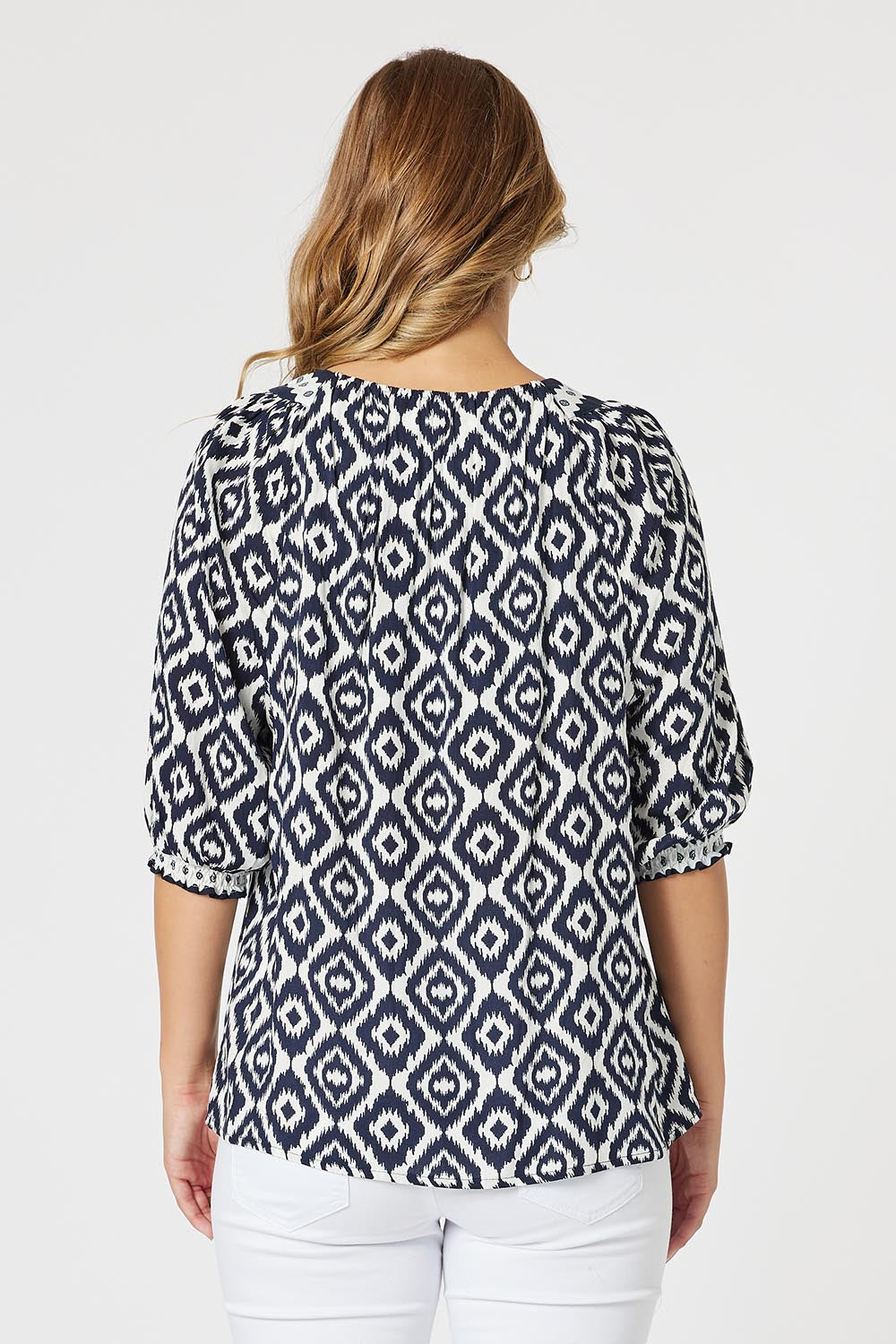 A model wearing the Diamonds Are Forever Top in colour Navy (Blue), from the back