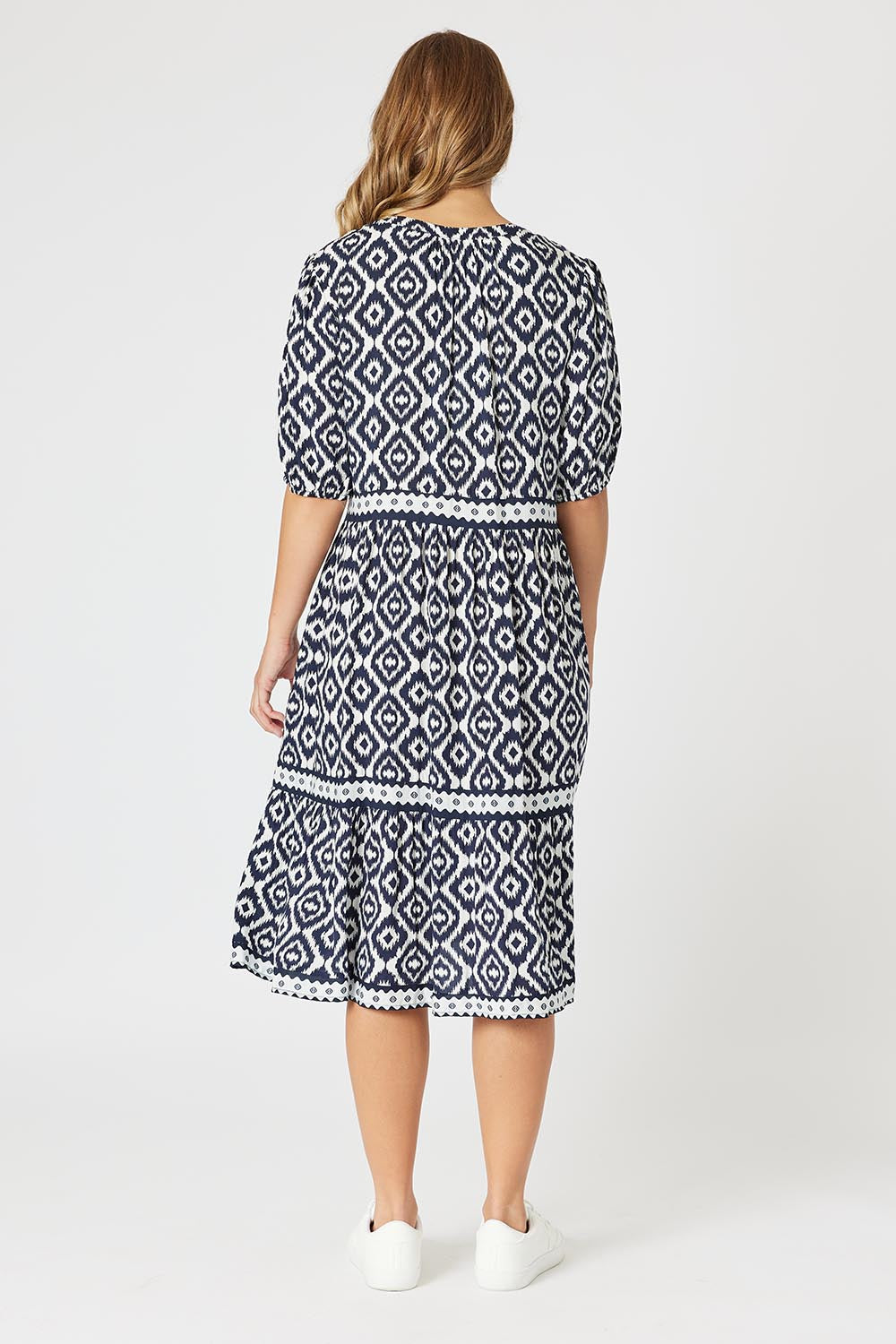 A model wearing the Diamonds Are Forever Dress in colour Navy (Blue), from the back