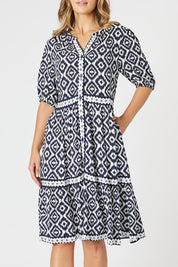 A model wearing the Diamonds Are Forever Dress in colour Navy (Blue), from the front, cropped image