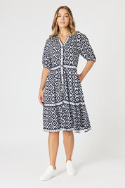 A model wearing the Diamonds Are Forever Dress in colour Navy (Blue), from the front, showing the whole outfit