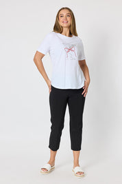 A model wearing the Martini Cotton Tee in colour White (White), from the front, showing the whole outfit