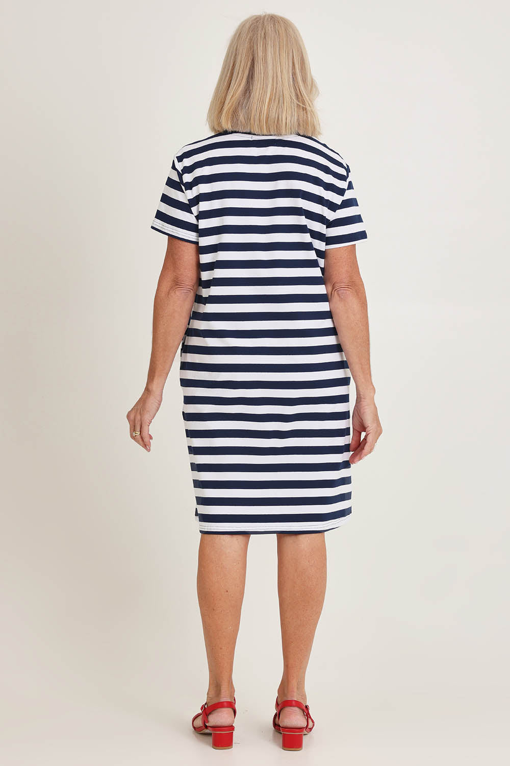 Model Sandy wearing size S of the Red Bow Stripe Cotton Dress in colour Navy (Blue), from the back