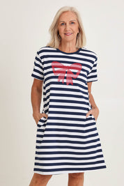 Model Sandy wearing size S of the Red Bow Stripe Cotton Dress in colour Navy (Blue), from the front, cropped image