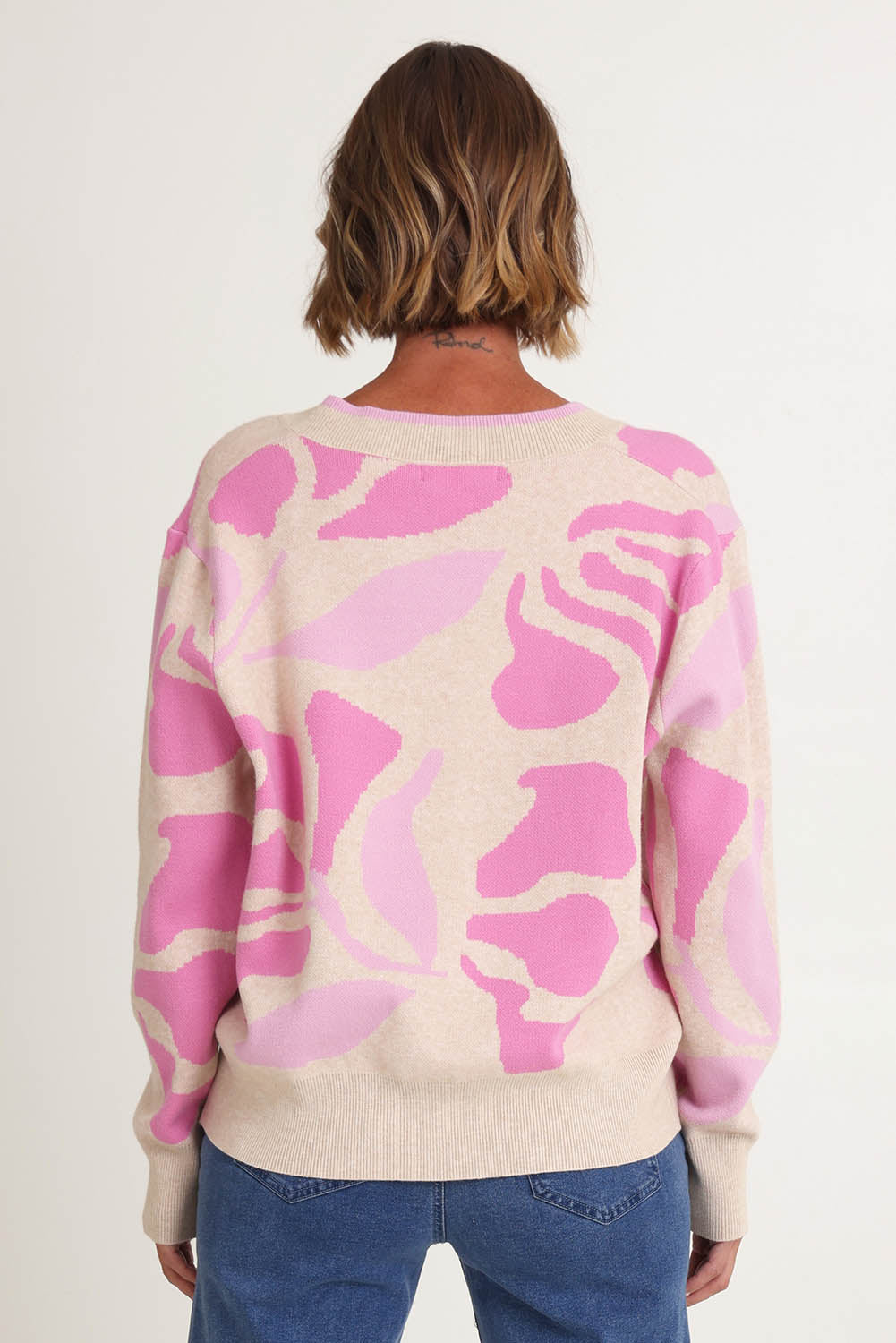 Model Riina wearing size S of the Blushing Knit in colour Pink (Pink), from the back