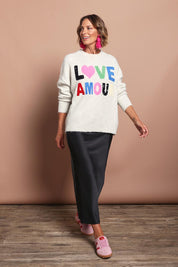 Model Riina wearing size S of the Love Amour Knit in colour Natural, from the front, showing the whole outfit