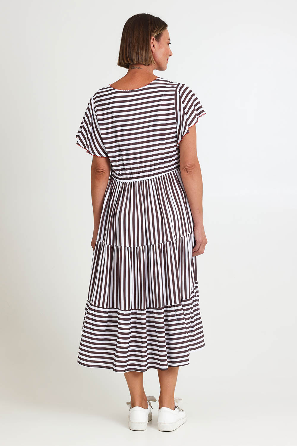 Model Riinar wearing size 10 of the Kalahari Stripe Dress – Coffee in colour Coffee, from the front