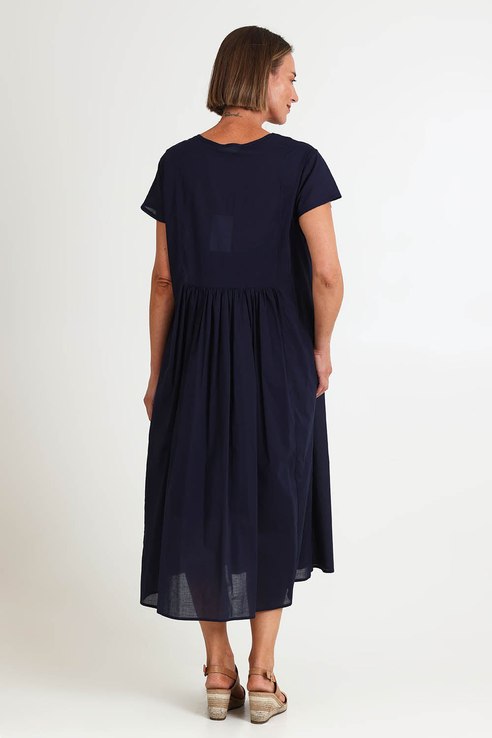 Model Riinar wearing size 10 of the Acacia Cotton Dress – Navy in colour Navy, from the front