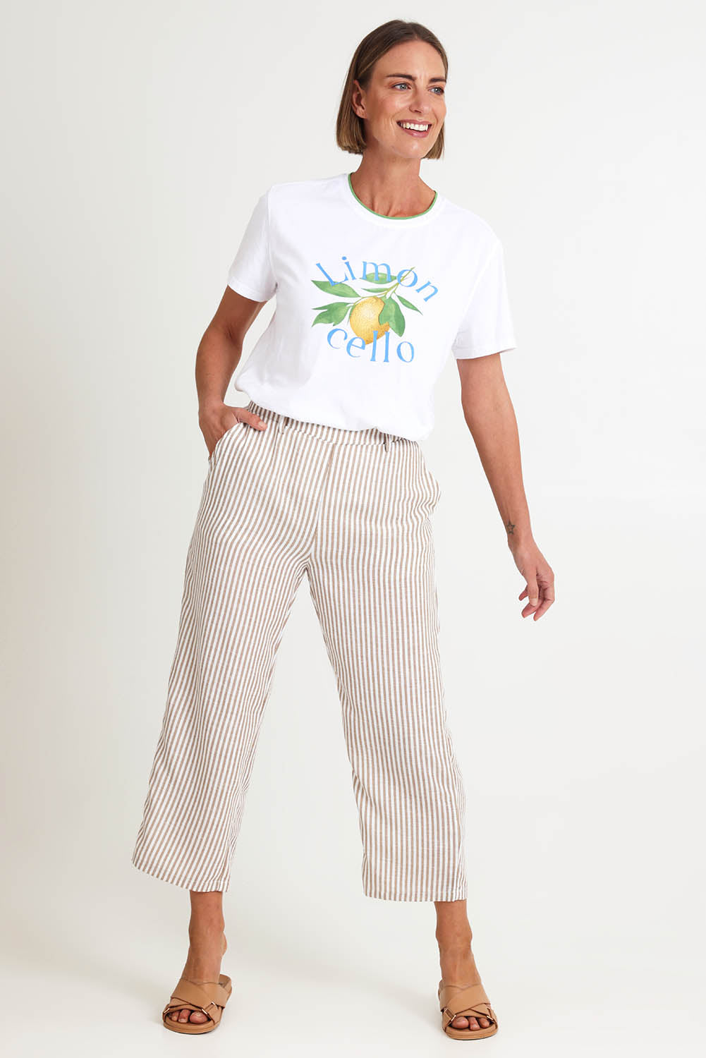 Model Riinar wearing size 10 of the Urban Stripe Pant – Natural in colour Natural, from the front