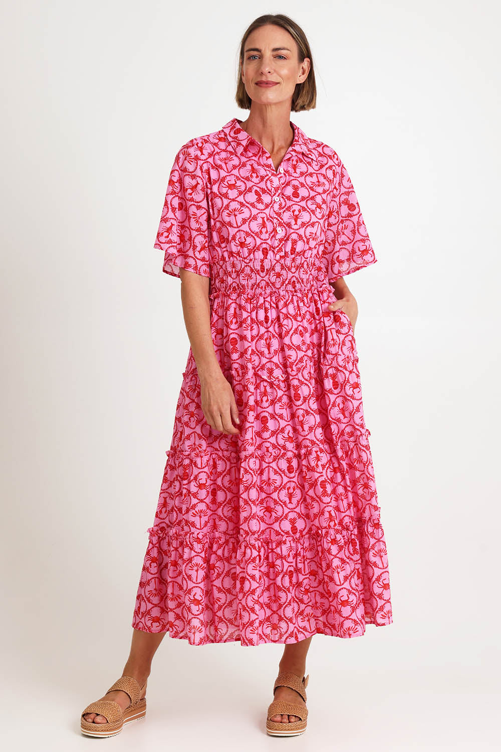 Model Riinar wearing size 10 of the Laguna Beach Print Dress – Rose in colour Rose, from the front