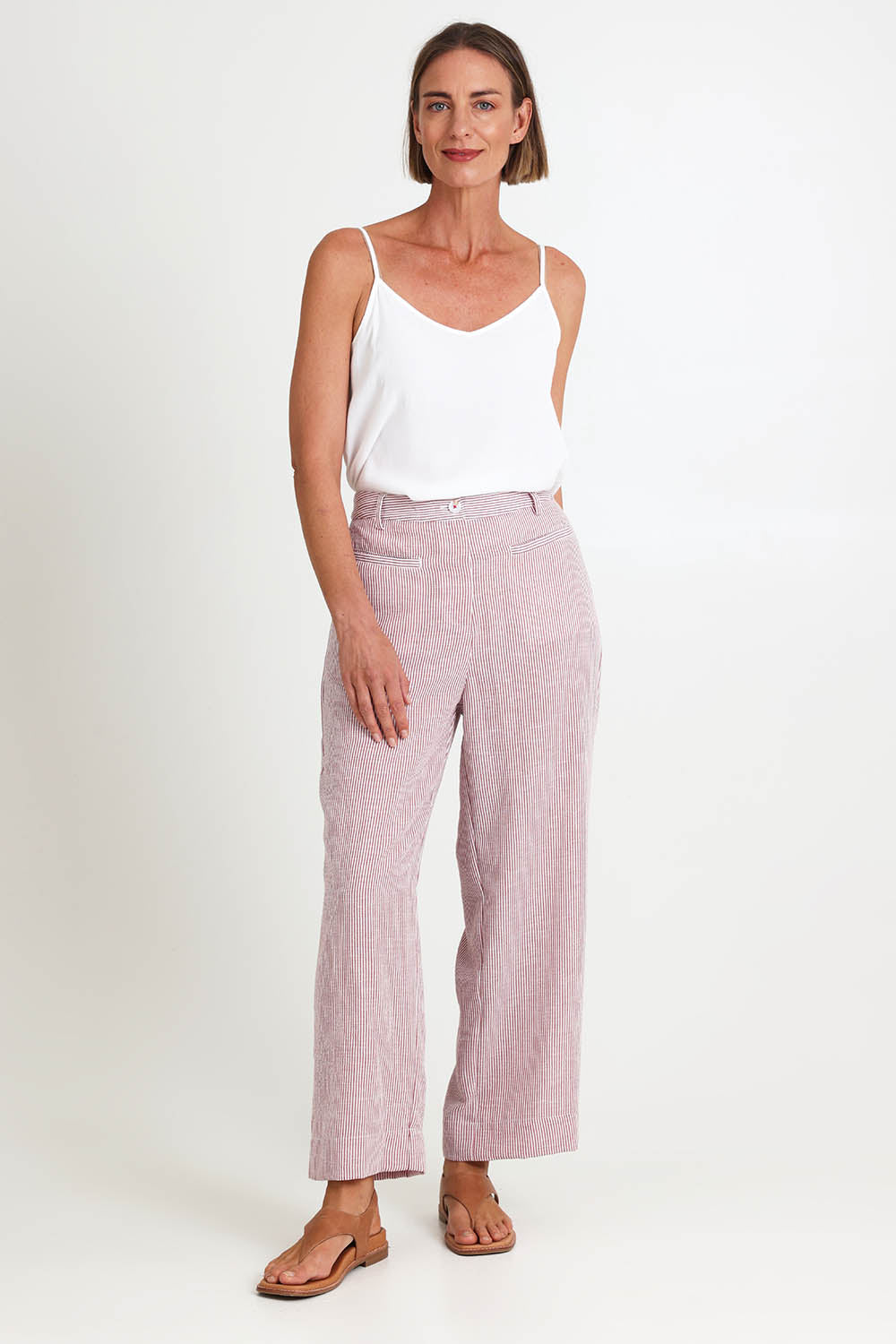 Model Riinar wearing size 10 of the City Stripe Pant - Redwhite in colour Redwhite, from the front