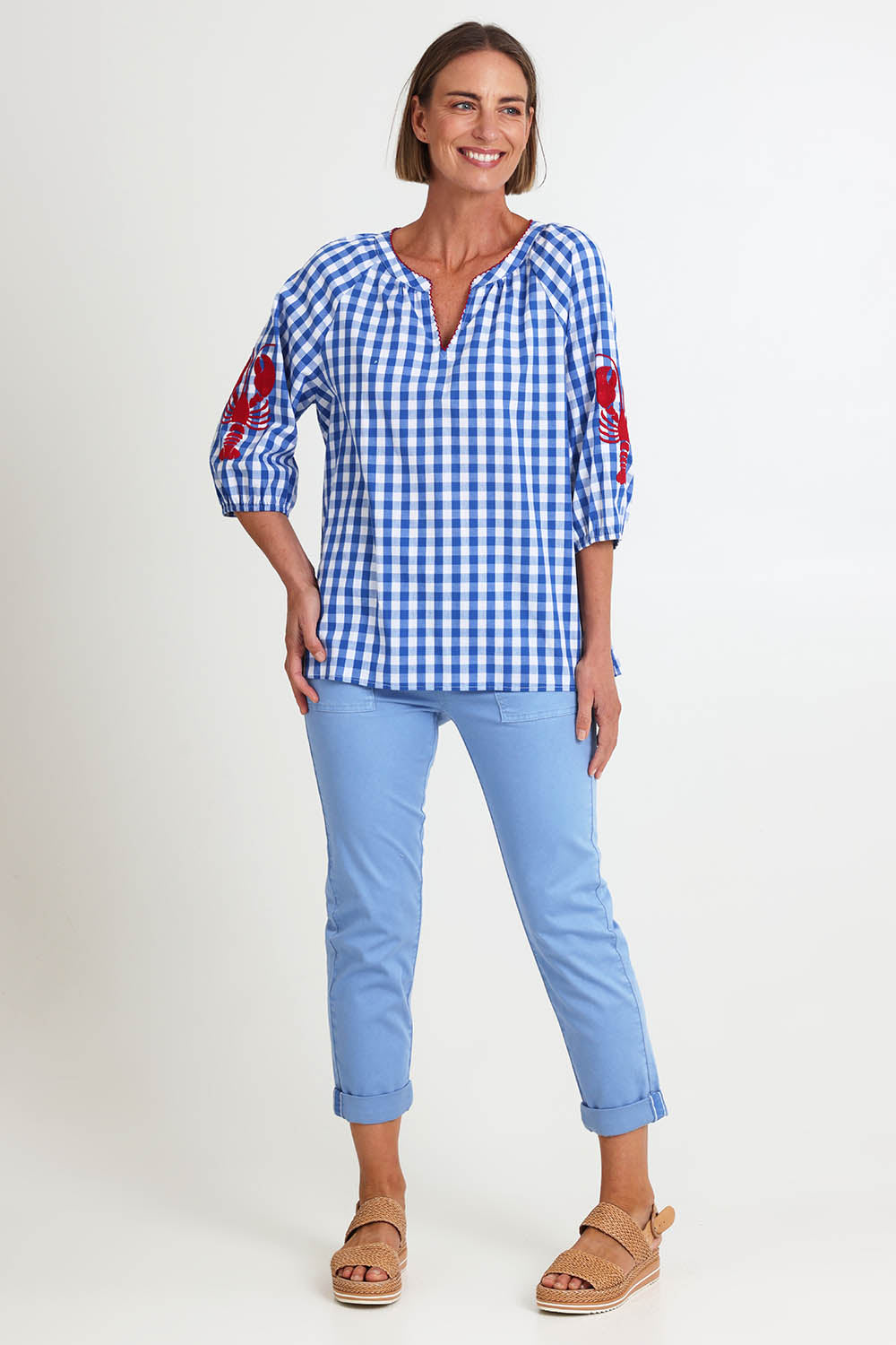Model Riinar wearing size 10 of the Cove Check Top – Azure in colour Azure, from the front