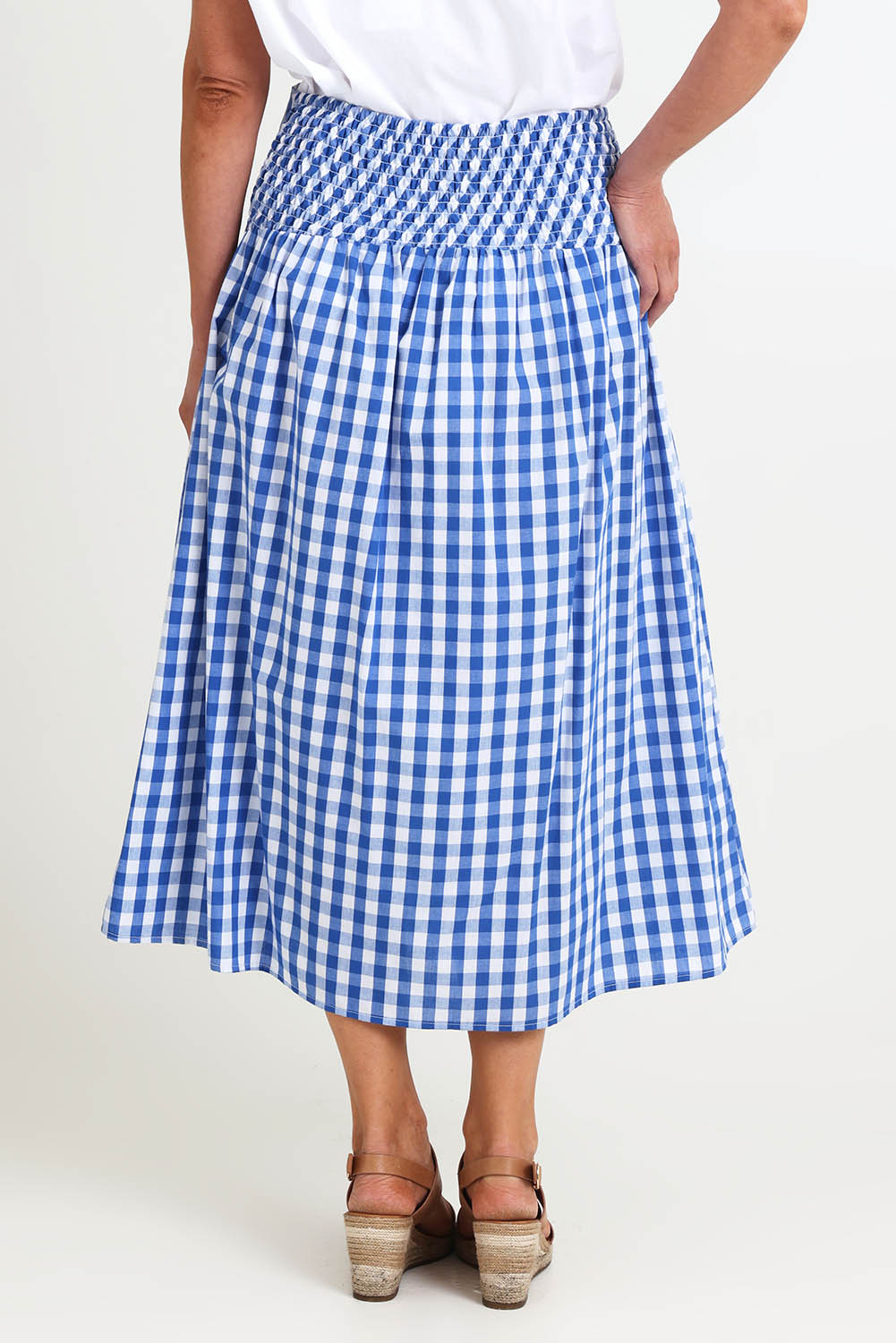 Model Riinar wearing size 10 of the Amalfi Check Skirt – Azure in colour Azure, from the back