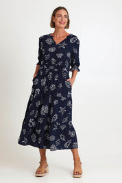 Model Riinar wearing size 10 of the Montecito Print Dress – Navy in colour Navy, from the front