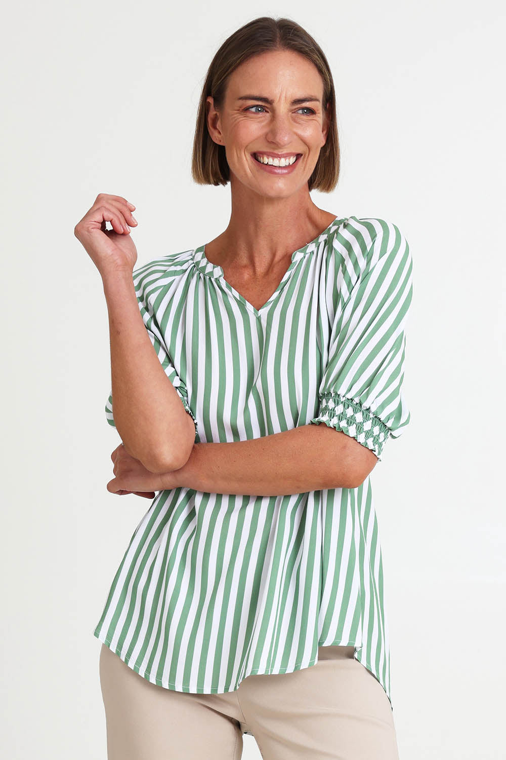 Model Riinar wearing size 10 of the Kalahari Stripe Top – Apple in colour Apple, from an angle