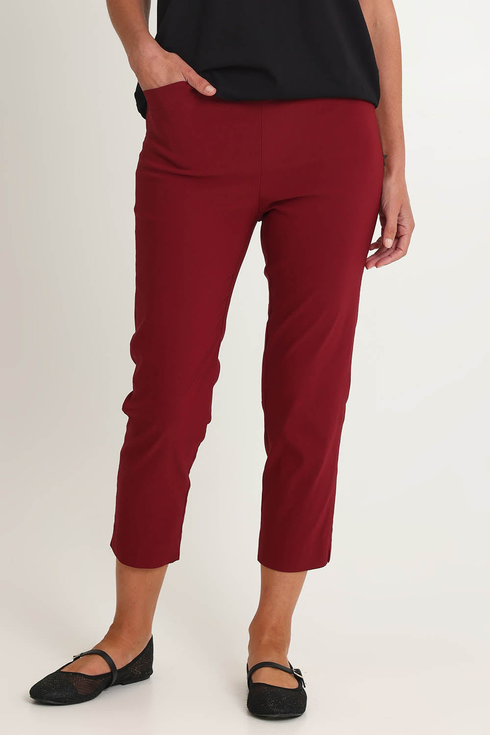 Model Riina wearing size S of the Zara Pant in colour Shiraz (Red), from the front, cropped image
