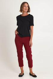 Model Riina wearing size S of the Zara Pant in colour Shiraz (Red), from the front, showing the whole outfit