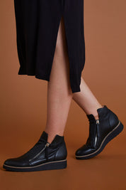 A model wearing size 40 of the Ohmy Ankle Boot in colour Blackblack (Black), from the front, cropped image