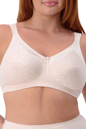 A model wearing the Endless Comfort Wirefree Bra in colour Freshpowde, from the front, cropped image