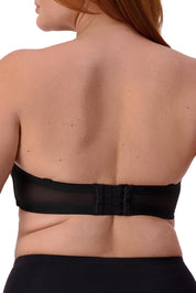 A model wearing the Beautiful Silhouette Bra in colour Black (Black), from the back