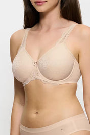 A model wearing the Contouring Sensation Minimiser Bra in colour Nudebeige, from the front, cropped image
