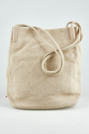 A model wearing size OneSize of the Natural Jute Long Handle Bag in colour Beige, from the front, showing the whole outfit