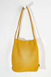 A model wearing size OneSize of the Natural Jute Long Handle Bag in colour Mustard, from the front, showing the whole outfit