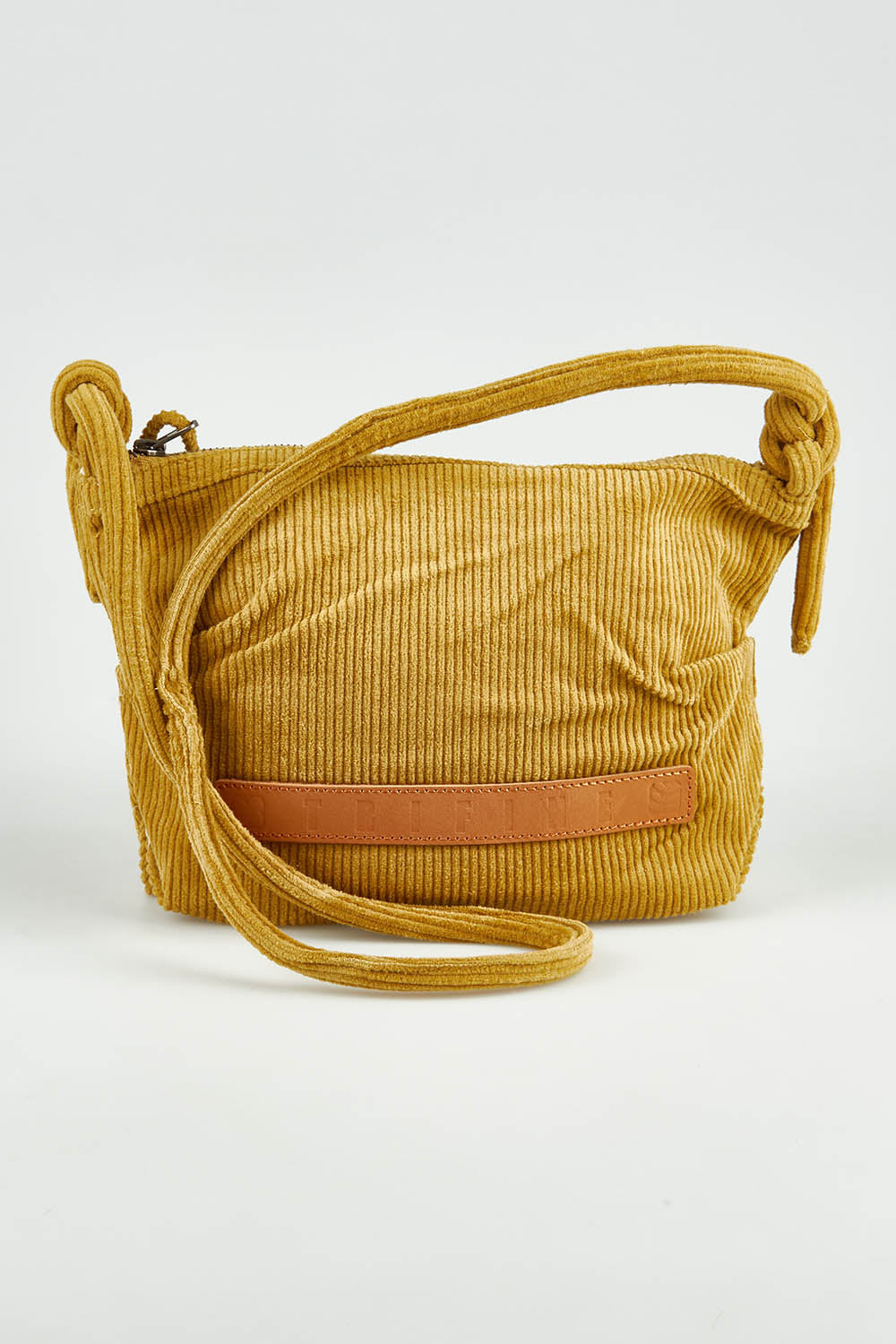 A model wearing the Corduroy Crossbody Bag in colour Mustard, from the front, showing the whole outfit
