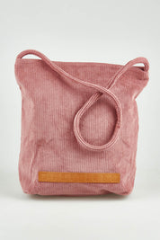 A model wearing the Corduroy Tote Bag in colour Blush (Pink), from the front, showing the whole outfit