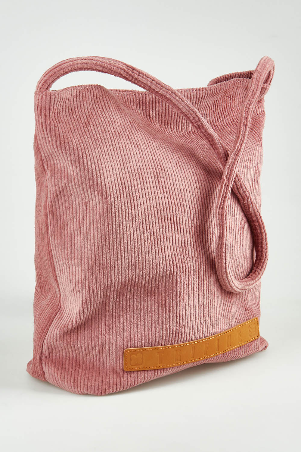A model wearing the Corduroy Tote Bag in colour Blush (Pink), from the front, showing the whole outfit