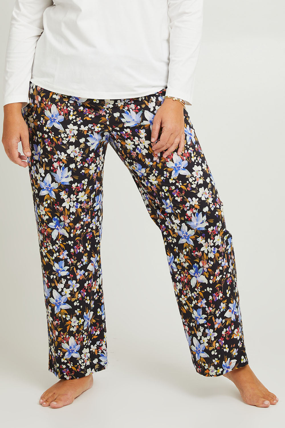 Model Fiona wearing the Winter Solstice Mercerised Cotton PJ Pants in colour Solstice (Black), from the front, cropped image