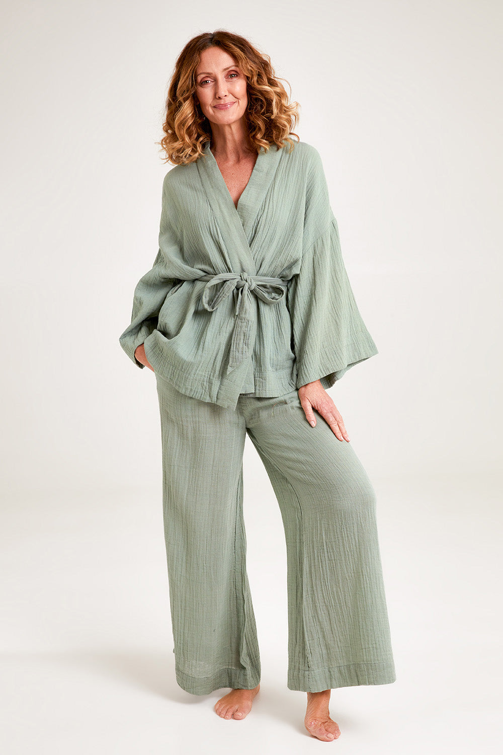 Model Emma wearing the Cotton Kimono With Belt in colour Sage (Green), from the front, showing the whole outfit