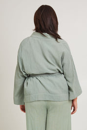 Model Poppy wearing the Cotton Kimono With Belt in colour Sage (Green), from the back
