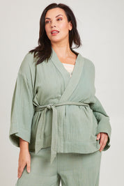 Model Poppy wearing the Cotton Kimono With Belt in colour Sage (Green), from the front, cropped image