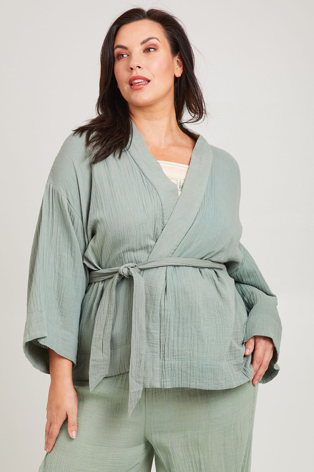 Model Poppy wearing the Cotton Kimono With Belt in colour Sage (Green), from the front, cropped image