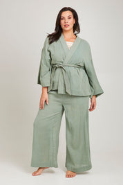 Model Poppy wearing the Cotton Kimono With Belt in colour Sage (Green), from the front, showing the whole outfit