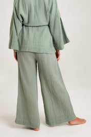 Model Emma wearing the Cotton Wide Leg Lounge Pant in colour Sage (Green), from the back