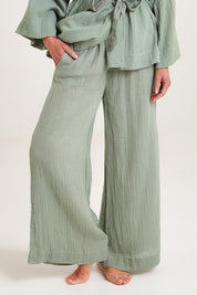 Model Emma wearing the Cotton Wide Leg Lounge Pant in colour Sage (Green), from the front, cropped image