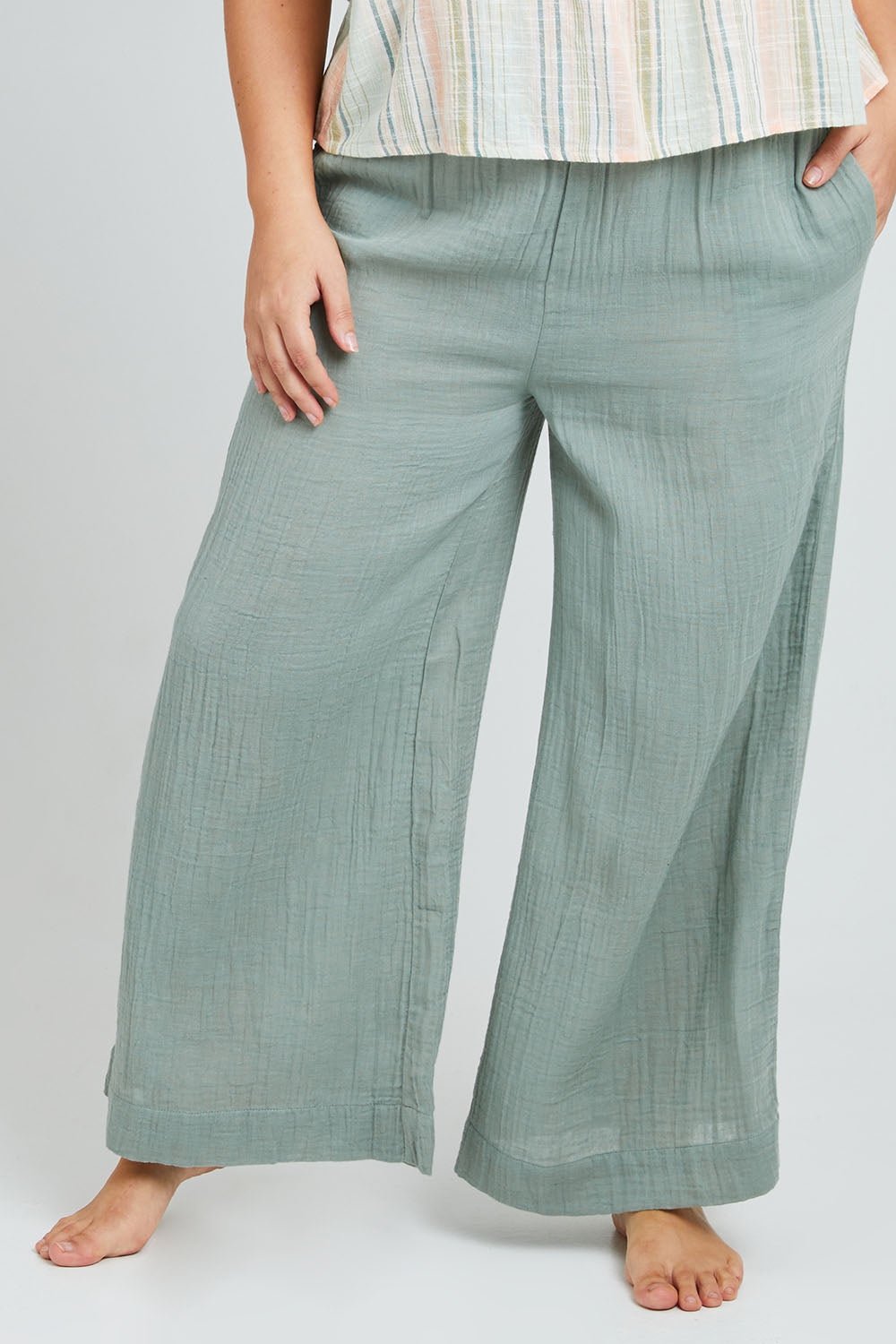 Model Poppy wearing the Cotton Wide Leg Lounge Pant in colour Sage (Green), from the front, cropped image